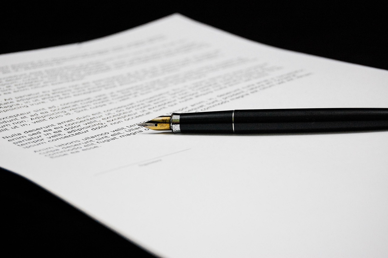 Editorial photo for Breach Of Manufacturing Quality Agreement: Protecting Product Standards, showing legal research and consultation documents.
