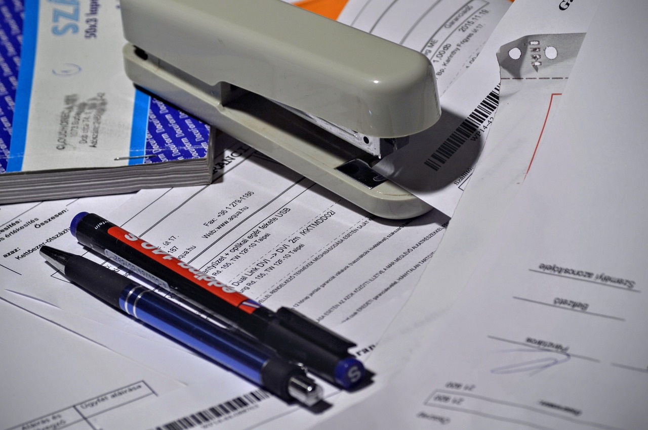 Editorial photo for Can I Sue My Employer for Gross Negligence After Workers Comp Settlement, showing employment records and workplace documents.