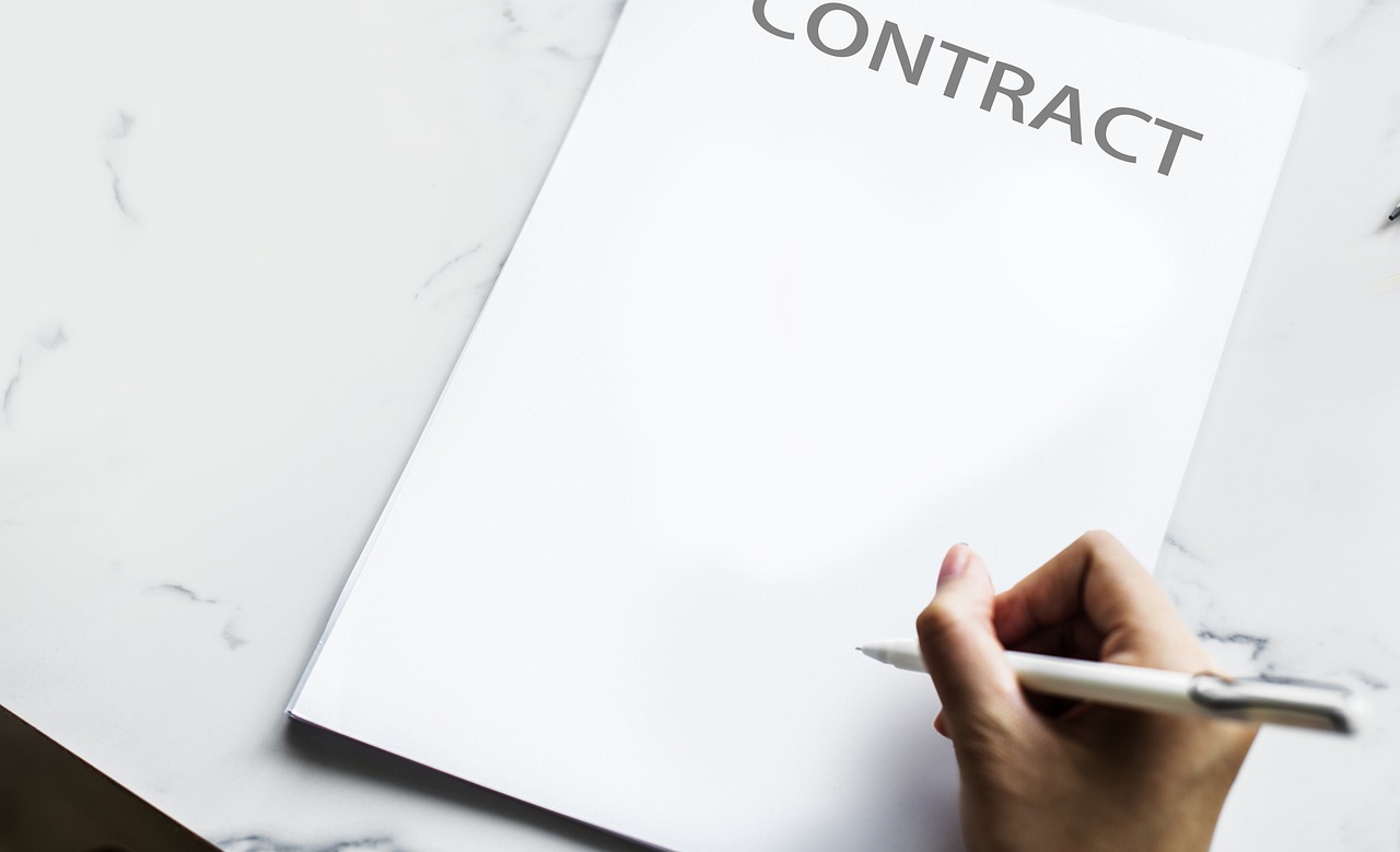Editorial photo for Discrimination In Business Franchise Opportunities: Seeking Redress For Biased Selection And Discriminatory Practices, showing business contracts, invoices, and settlement paperwork.